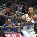 
              Orlando Magic's Markelle Fultz (20) looks for a shot against Toronto Raptors' Pascal Siakam, left, during the second half of an NBA basketball game Friday, Dec. 9, 2022, in Orlando, Fla. (AP Photo/John Raoux)
            