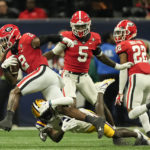 
              Georgia linebacker Smael Mondon Jr. (2) tries to escape from LSU wide receiver Brian Thomas Jr. (11) after intercepting a pass in the first half of the Southeastern Conference Championship football game Saturday, Dec. 3, 2022 in Atlanta. (AP Photo/John Bazemore)
            