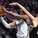 
              San Diego State guard Micah Parrish (3) shoots against Occidental guard Nicky Clotfelter (23) during the first half of an NCAA college basketball game Friday, Dec. 2, 2022, in San Diego. (AP Photo/Denis Poroy)
            