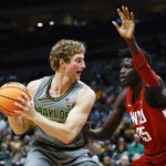 
              Baylor forward Caleb Lohner (33) battles Washington State forward Mouhamed Gueye (35) for space during the first half of an NCAA college basketball game, Sunday, Dec. 18, 2022, in Dallas. (AP Photo/Brandon Wade)
            