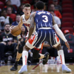 
              Miami Heat guard Tyler Herro, left, looks to drive around Houston Rockets guard Kevin Porter Jr. (3) during the first half of an NBA basketball game Thursday, Dec. 15, 2022, in Houston. (AP Photo/Michael Wyke)
            