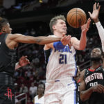 
              Orlando Magic center Moritz Wagner (21) is fouled by Houston Rockets guard Jalen Green (4) as center Bruno Fernando, right, helps defend during the first half of an NBA basketball game Wednesday, Dec. 21, 2022, in Houston. (AP Photo/Eric Christian Smith)
            