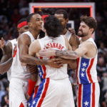 
              Brooklyn Nets guard Kyrie Irving (obcscured) is embraced by teammates after hitting the winning shot against the Toronto Raptors during an NBA basketball game in Toronto, Friday, Dec. 16, 2022. (Cole Burston/The Canadian Press via AP)
            