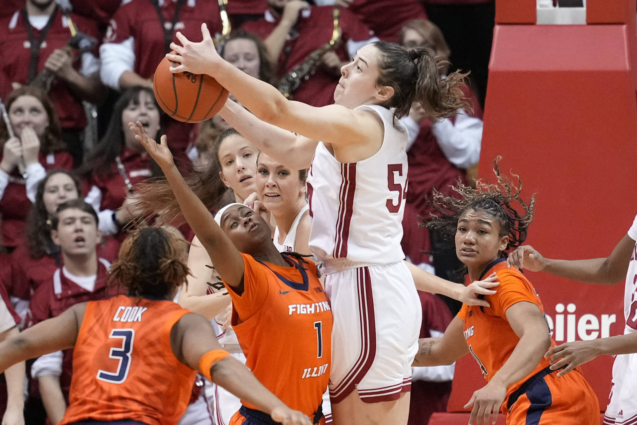 Indiana forward Mackenzie Holmes (54) fights for a rebound with Illinois guard Genesis Bryant (1) i...