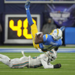 
              Los Angeles Chargers tight end Stone Smartt, top, is tackled by Miami Dolphins cornerback Kader Kohou during the second half of an NFL football game Sunday, Dec. 11, 2022, in Inglewood, Calif. (AP Photo/Mark J. Terrill)
            