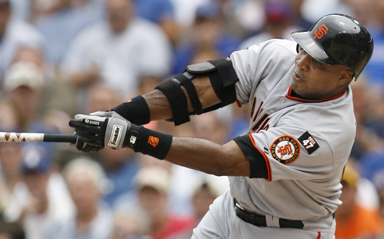 FILE - San Francisco Giants' Barry Bonds hits a single against the Chicago Cubs during the third in...