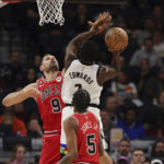 
              Minnesota Timberwolves guard Anthony Edwards (1) is fouled by Chicago Bulls center Nikola Vucevic (9) during the first half of an NBA basketball game Sunday, Dec. 18, 2022, in Minneapolis. (AP Photo/Stacy Bengs)
            