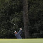 
              FILE - Scottie Scheffler hits out of the rough after taking a drop on the 18th fairway during the third round at the Masters golf tournament on Saturday, April 9, 2022, in Augusta, Ga. His 3-iron shot allowed him to salvage bogey for a three-shot lead.(AP Photo/Matt Slocum, File)
            