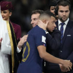 
              France's President Emmanuel Macron and his wife Brigitte embraces France's Kylian Mbappe at the end of the World Cup final soccer match between Argentina and France at the Lusail Stadium in Lusail, Qatar, Sunday, Dec. 18, 2022. Argentina won 4-2 in a penalty shootout after the match ended tied 3-3. (AP Photo/Martin Meissner)
            