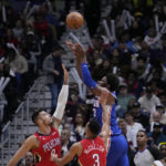 
              Philadelphia 76ers center Joel Embiid (21) is fouled while making a basket, as he is covered by New Orleans Pelicans center Willy Hernangomez and guard CJ McCollum (3) during the first half of an NBA basketball game in New Orleans, Friday, Dec. 30, 2022. (AP Photo/Gerald Herbert)
            