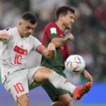 
              Switzerland's Granit Xhaka, left, and Portugal's Otavio challenge for the ball during the World Cup round of 16 soccer match between Portugal and Switzerland, at the Lusail Stadium in Lusail, Qatar, Tuesday, Dec. 6, 2022. (AP Photo/Darko Bandic)
            