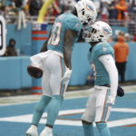 
              Miami Dolphins wide receiver Tyreek Hill (10) celebrates catching a pass with Miami Dolphins wide receiver Jaylen Waddle (17), during the first half of an NFL football game, Sunday, Dec. 25, 2022, in Miami Gardens, Fla. (AP Photo/Rhona Wise)
            