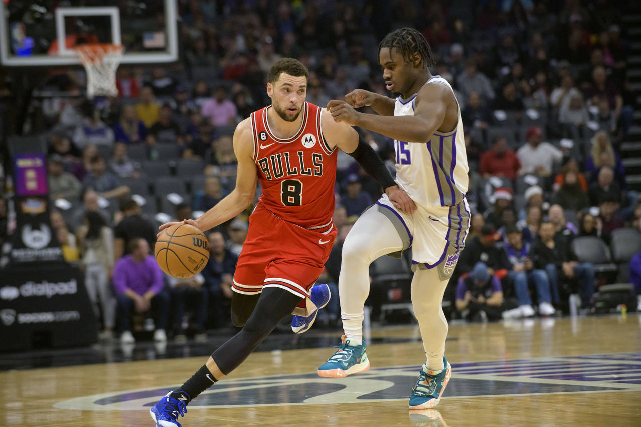 Chicago Bulls guard Zach LaVine (8) is guarded by Sacramento Kings guard Davion Mitchell (15) durin...