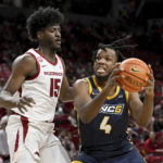 
              UNC Greensboro forward Mohammed Abdulsalam (4) tries to drive past Arkansas forward Makhi Mitchell (15) during the first half of an NCAA college basketball game Tuesday, Dec. 6, 2022, in Fayetteville, Ark. (AP Photo/Michael Woods)
            