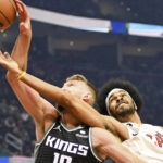 
              Cleveland Cavaliers center Jarrett Allen, right, fights for a rebound against Sacramento Kings forward Domantas Sabonis during the first half of an NBA basketball game, Friday, Dec. 9, 2022, in Cleveland. (AP Photo/Nick Cammett)
            