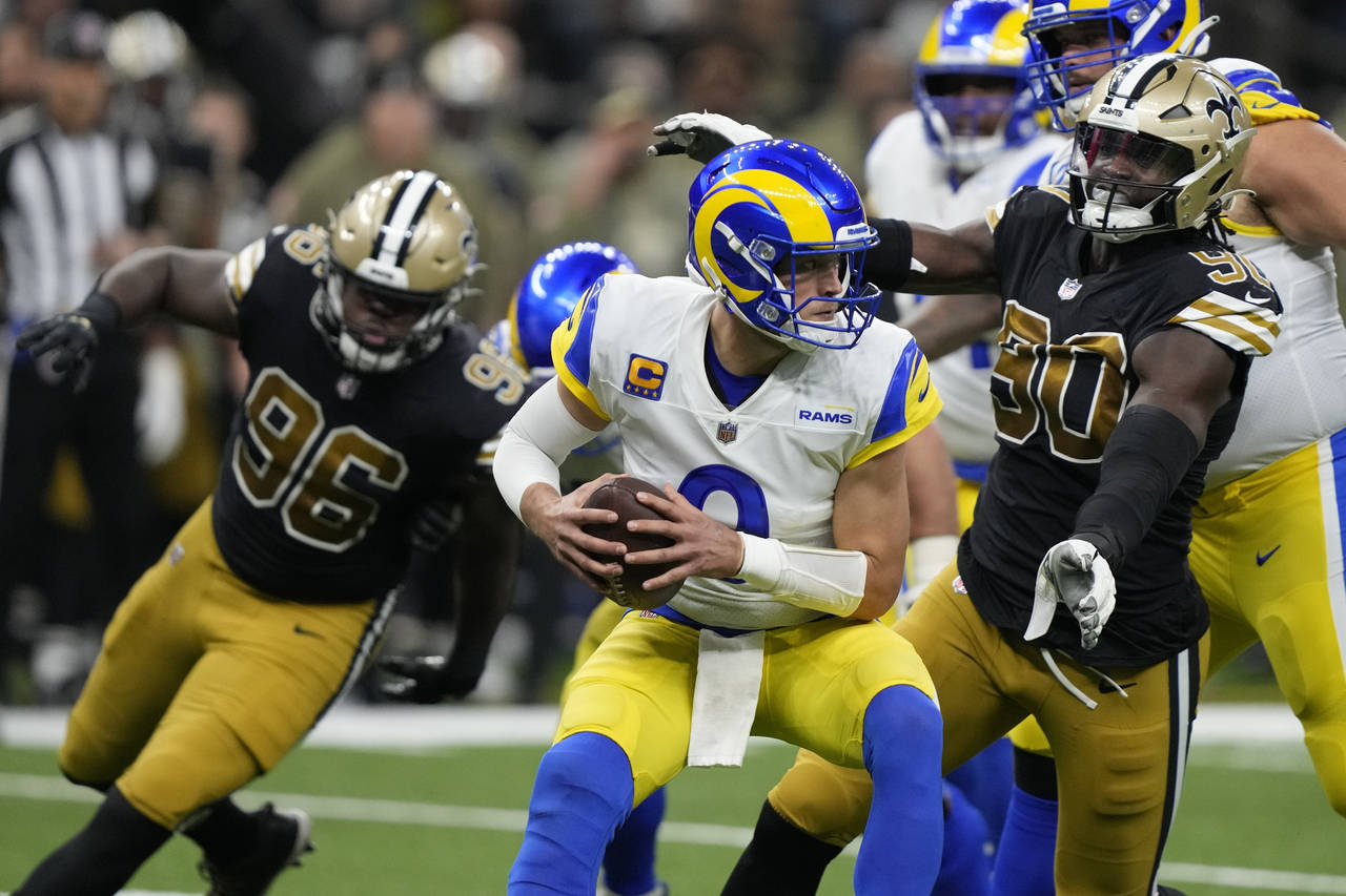 Los Angeles Rams quarterback Matthew Stafford, center, is sacked by New Orleans Saints defensive en...