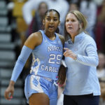 
              FILE - North Carolina coach Courtney Banghart talks with Deja Kelly during the first half of the team's NCAA college basketball game against Indiana, Thursday, Dec. 1, 2022, in Bloomington, Ind. Women's college basketball has typically kept players around compared to the frequent early exits to the professional ranks that are so common on the men's side. But the women's game has gotten even older with players having extra eligibility from the COVID-19 pandemic. That has first-year players facing more fifth- and sixth-year players, creating a bigger gap to overcome in experience and strength than before. (AP Photo/Darron Cummings, File)
            