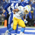 
              Los Angeles Chargers' Austin Ekeler (30) celebrates a touchdown run during the second half of an NFL football game against the Indianapolis Colts, Monday, Dec. 26, 2022, in Indianapolis. (AP Photo/Michael Conroy)
            