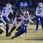 
              Buffalo Bills running back Devin Singletary (26) cuts away from Chicago Bears cornerback Jaquan Brisker (9) on his way to a touchdown in the second half of an NFL football game in Chicago, Saturday, Dec. 24, 2022. (AP Photo/Charles Rex Arbogast)
            