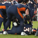 
              Denver Broncos quarterback Russell Wilson (3) is on the ground after being hit during the second half of an NFL football game against the Kansas City Chiefs Sunday, Dec. 11, 2022, in Denver. (AP Photo/David Zalubowski)
            