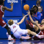 
              Indiana forward Race Thompson (25) gets a pass off to guard Xavier Johnson (0) during a scramble as Kansas guard Gradey Dick (4) defends during the first half of an NCAA college basketball game in Lawrence, Kan., Saturday, Dec. 17, 2022. (AP Photo/Reed Hoffmann)
            