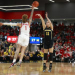 
              Michigan guard Greta Kampschroeder, right, shoots in front of Ohio State guard Rikki Harris during the first half of an NCAA college basketball game in Columbus, Ohio, Saturday, Dec. 31, 2022. (AP Photo/Paul Vernon)
            