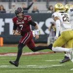 
              South Carolina quarterback Spencer Rattler (7) scrambles during the second quarter of the Gator Bowl NCAA college football game against Notre Dame on Friday, Dec. 30, 2022, in Jacksonville, Fla. (AP Photo/Gary McCullough)
            