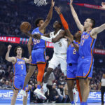 
              Cleveland Cavaliers guard Caris LeVert (3) shoots against Oklahoma City Thunder forward Jeremiah Robinson-Earl (50), guard Shai Gilgeous-Alexander (2) and forward Aleksej Pokusevski (17) during the first half of an NBA basketball game, Saturday, Dec. 10, 2022, in Cleveland. (AP Photo/Ron Schwane)
            
