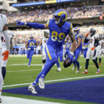
              Los Angeles Rams tight end Tyler Higbee celebrates after scoring past Denver Broncos cornerback Pat Surtain II during the first half of an NFL football game between the Los Angeles Rams and the Denver Broncos on Sunday, Dec. 25, 2022, in Inglewood, Calif. (AP Photo/Jae C. Hong)
            