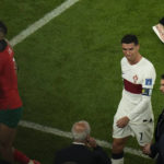 
              Portugal's Cristiano Ronaldo, right, reacts as he walks off the field after their loss in the World Cup quarterfinal soccer match against Morocco, at Al Thumama Stadium in Doha, Qatar, Saturday, Dec. 10, 2022. (AP Photo/Alessandra Tarantino)
            