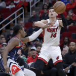 
              Houston Rockets guard TyTy Washington Jr., left, fouls Miami Heat guard Tyler Herro (14) as he attempts a shot during the first half of an NBA basketball game Thursday, Dec. 15, 2022, in Houston. (AP Photo/Michael Wyke)
            