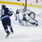 
              Winnipeg Jets' Pierre-Luc Dubois (80) scores on a penalty shot against Vancouver Canucks goaltender Collin Delia (60) during second-period NHL hockey game action in Winnipeg, Manitoba, Thursday, Dec. 29, 2022. (John Woods/The Canadian Press via AP)
            