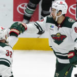 
              Minnesota Wild center Frederick Gaudreau (89) is congratulated by teammate Alex Goligoski (33) after Gaudreau scores a shoot-out in an NHL hockey game against the Dallas Stars in Dallas, Sunday, Dec. 4, 2022. The Wild won 6-5. (AP Photo/LM Otero)
            