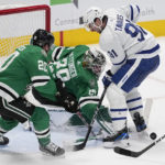 
              Dallas Stars goaltender Jake Oettinger blocks a shot by Toronto Maple Leafs center John Tavares as defenseman Ryan Suter (20) helps defend on thee play in the second period of an NHL hockey game, Tuesday, Dec. 6, 2022, in Dallas. (AP Photo/Tony Gutierrez)
            