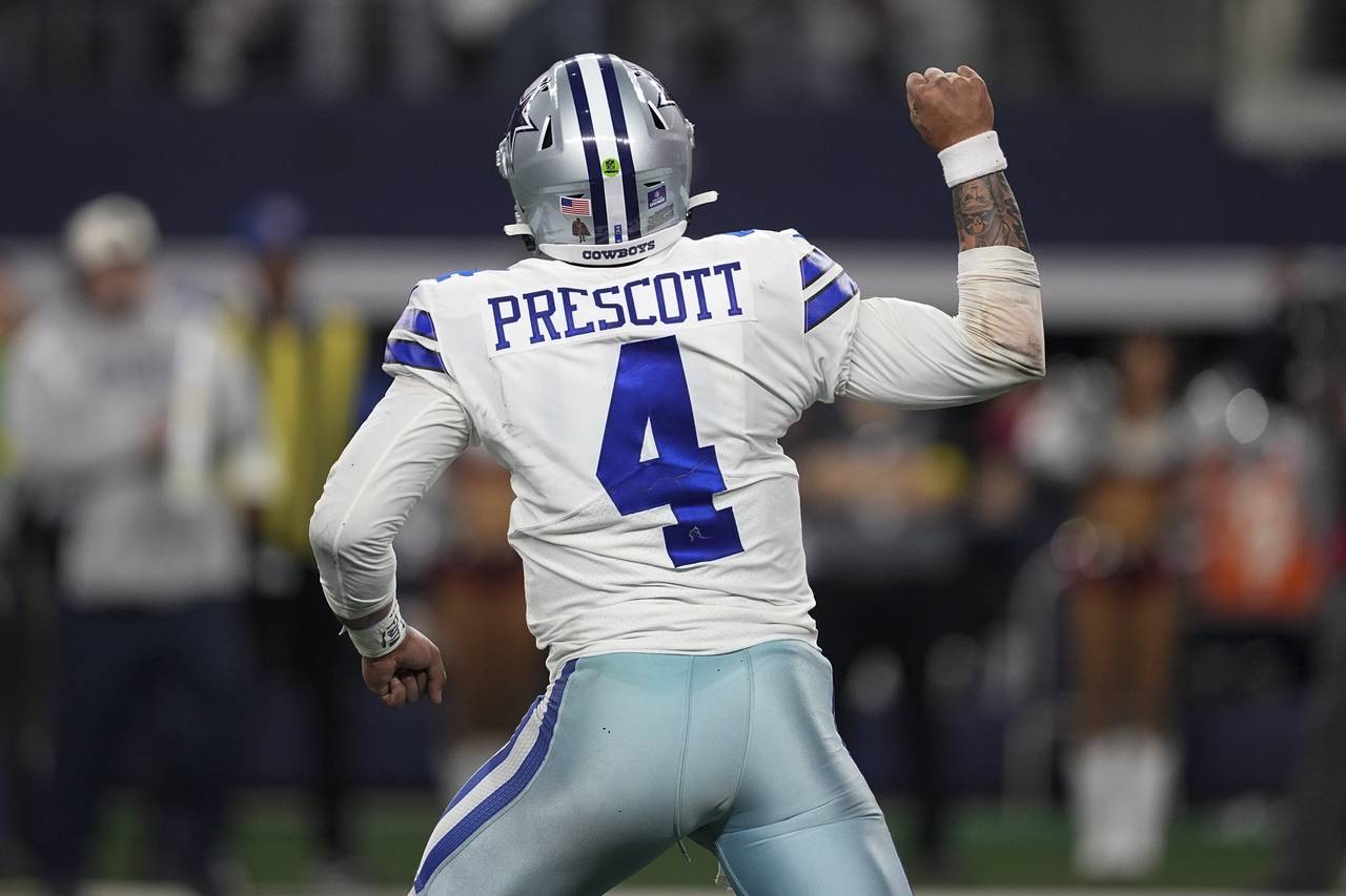 Dallas Cowboys' Dak Prescott celebrates a touchdown during the second half of an NFL football game ...