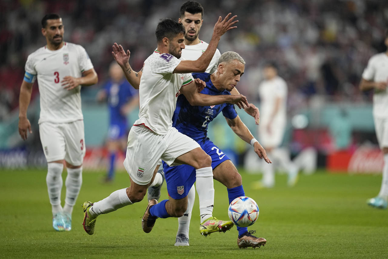 FILE - Sergino Dest of the United States fights for the ball with Iran's Milad Mohammadi during the...