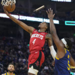 
              Houston Rockets guard Jalen Green (4) shoots next to Golden State Warriors center Kevon Looney (5) during the first half of an NBA basketball game in San Francisco, Saturday, Dec. 3, 2022. (AP Photo/Godofredo A. Vásquez)
            