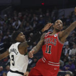 
              Chicago Bulls forward DeMar DeRozan (11) goes up to the basket against Minnesota Timberwolves forward Jaden McDaniels (3) during the first half of an NBA basketball game Sunday, Dec. 18, 2022, in Minneapolis. (AP Photo/Stacy Bengs)
            