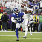 
              Minnesota Vikings wide receiver Justin Jefferson (18) catches a 17-yard touchdown pass ahead of New York Giants cornerback Fabian Moreau (37) during the second half of an NFL football game, Saturday, Dec. 24, 2022, in Minneapolis. (AP Photo/Bruce Kluckhohn)
            