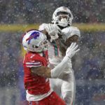 
              Miami Dolphins wide receiver Cedrick Wilson Jr. (11) catches a pass from quarterback Tua Tagovailoa with Buffalo Bills cornerback Taron Johnson (7) defending during the second half of an NFL football game in Orchard Park, N.Y., Saturday, Dec. 17, 2022. (AP Photo/Joshua Bessex)
            