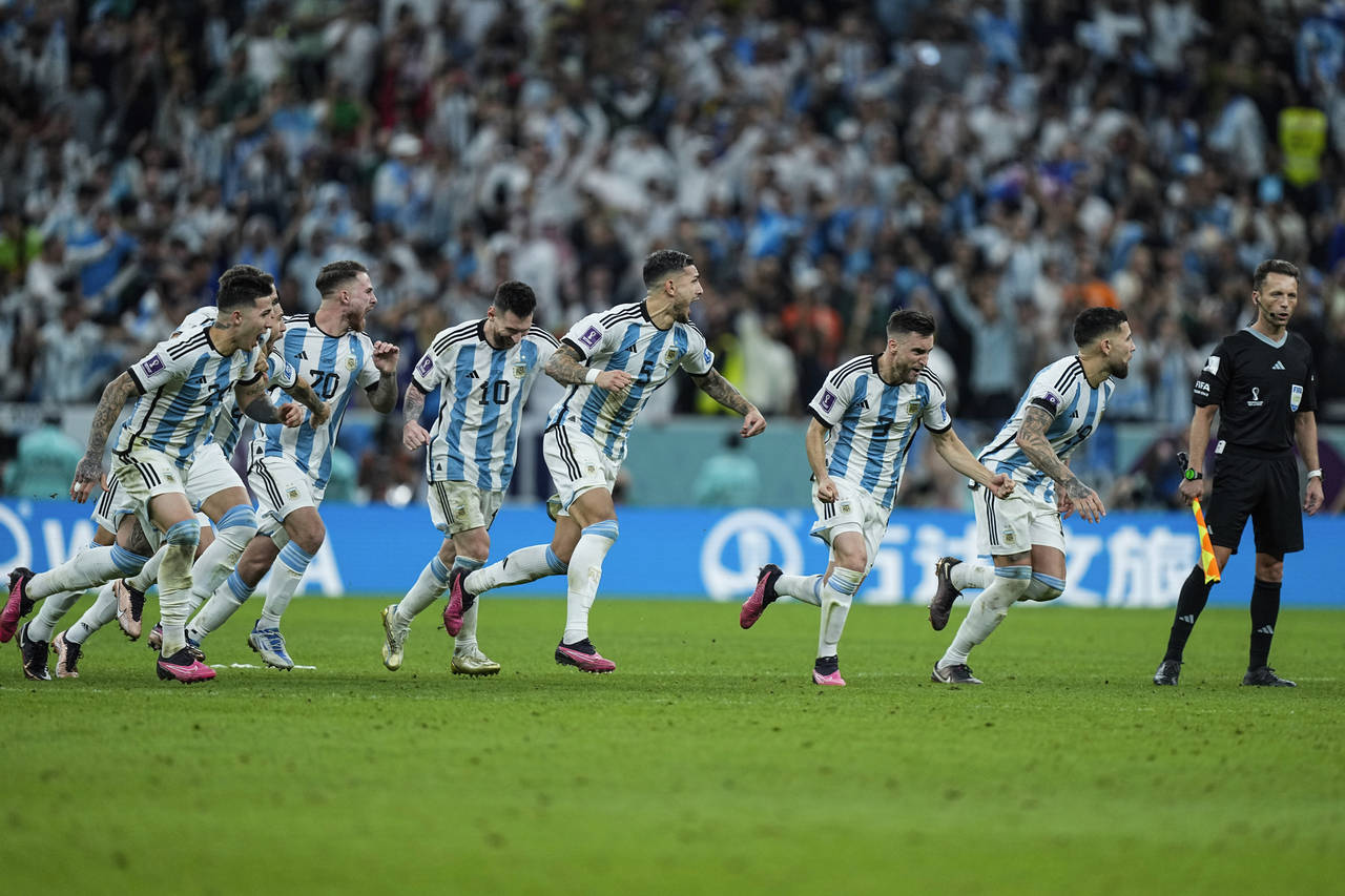 Argentina's players celebrate at the end of the World Cup quarterfinal soccer match between the Net...