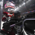 
              Los Angeles Kings left wing Alex Iafallo, right, and Calgary Flames defenseman Chris Tanev hit the glass during the first period of an NHL hockey game Thursday, Dec. 22, 2022, in Los Angeles. (AP Photo/Ashley Landis)
            