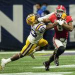 
              LSU linebacker Micah Baskerville (23) drags Georgia running back Kenny McIntosh (6) down in the second half of the Southeastern Conference Championship football game Saturday, Dec. 3, 2022 in Atlanta. (AP Photo/John Bazemore)
            