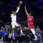
              Los Angeles Lakers' LeBron James, left, goes up for a shot against Philadelphia 76ers' Tobias Harris during the first half of an NBA basketball game, Friday, Dec. 9, 2022, in Philadelphia. (AP Photo/Matt Slocum)
            