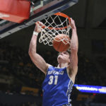 
              Buffalo center Isaac Jack dunks against West Virginia during the first half of an NCAA college basketball game in Morgantown, W.Va., Sunday, Dec. 18, 2022. (AP Photo/Kathleen Batten)
            