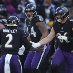 
              Baltimore Ravens quarterback Tyler Huntley (2) celebrates his touchdown pass with tight end Josh Oliver and tight end Nick Boyle (86) during the first half of an NFL football game, Saturday, Dec. 24, 2022, in Baltimore. (AP Photo/Julio Cortez)
            