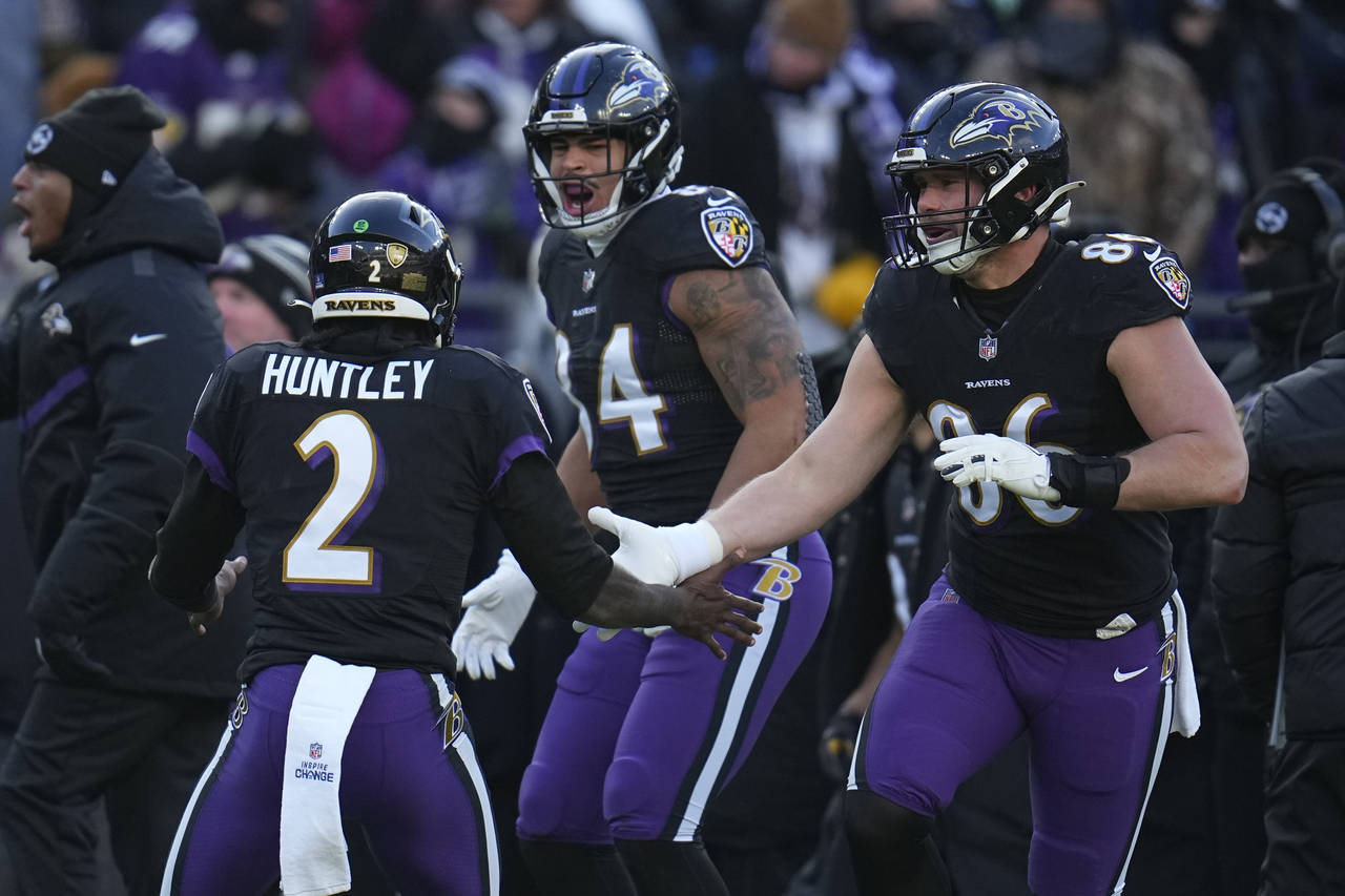 Baltimore Ravens quarterback Tyler Huntley (2) celebrates his touchdown pass with tight end Josh Ol...