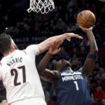 
              Portland Trail Blazers center Jusuf Nurkic, left, fouls Minnesota Timberwolves guard Anthony Edwards, right, during the first half of an NBA basketball game in Portland, Ore., Monday, Dec. 12, 2022. (AP Photo/Steve Dykes)
            
