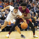 
              Virginia's Kadin Shedrick (21) and Florida State's Cam'ron Fletcher fight for the ballduring the first half of an NCAA college basketball game in Charlottesville, Va., Saturday, Dec. 3, 2022. (AP Photo/Mike Kropf)
            