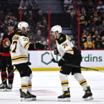 
              Boston Bruins left wing Jake DeBrusk (74) celebrates his goal against the Ottawa Senators with center Patrice Bergeron (37) during the second period of an NHL hockey game in Ottawa, Ontario, on Tuesday, Dec. 27, 2022. (Justin Tang/The Canadian Press via AP)
            